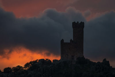 Low angle view of building against sky during sunset