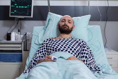 Male patient lying on bed at hospital