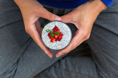 Vegan healthy eating and dieting food concept. female hands holding chia pudding