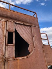 Low angle view of abandoned building against sky