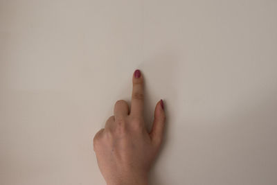 Close-up of human hand against white background