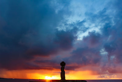 Silhouette man standing by sea against sky during sunset