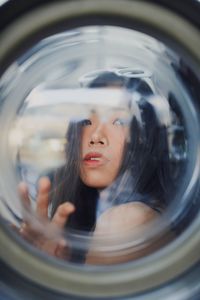 Portrait of woman seen through glass window