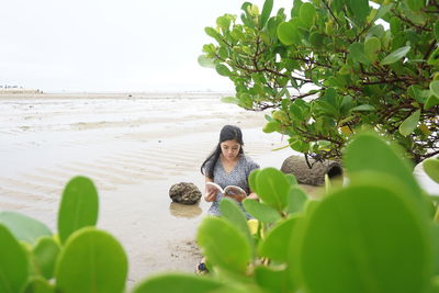 Woman sitting on beach