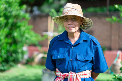 Portrait of woman wearing hat standing outdoors