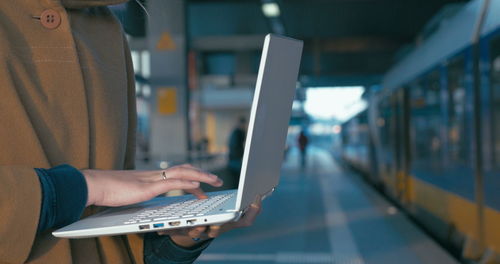 Midsection of woman using mobile phone