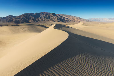 Scenic view of desert against clear sky