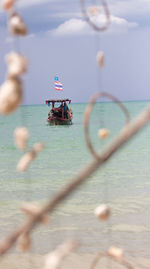 Nautical vessel on sea against sky