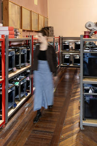 Side view of woman standing in factory