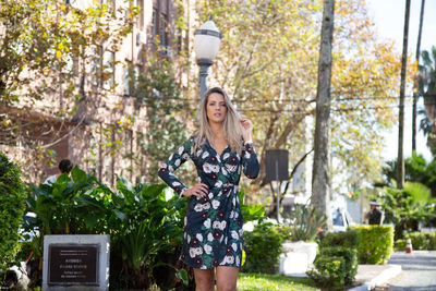 Portrait of woman standing on road