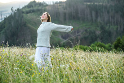 Rear view of woman standing on field