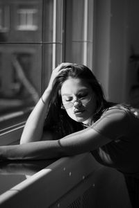 Portrait of a young woman sitting on floor