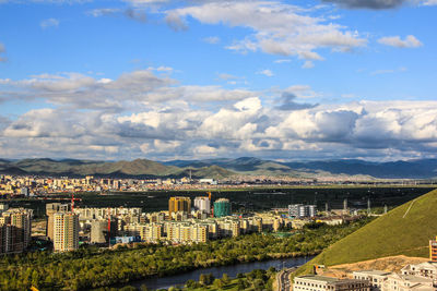 High angle view of river amidst buildings against sky