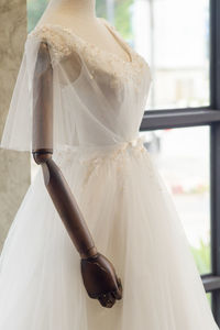 Wedding dress on mannequin in clothing store