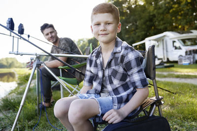 Portrait of smiling boy sitting outdoors