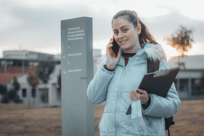 Portrait of young woman using digital tablet