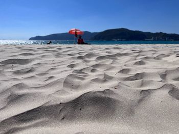 Rear view of man standing at beach