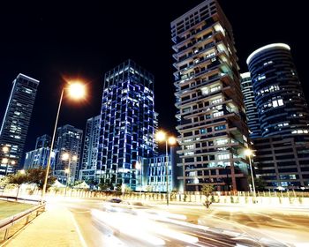 Illuminated city street at night