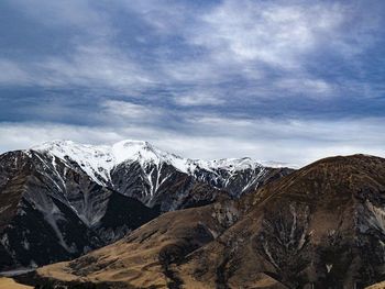 Scenic view of snowcapped mountains against sky