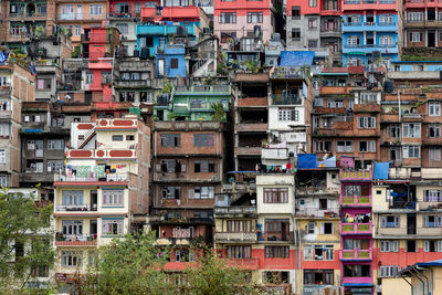 A closeup view of a city on a hill with the houses stacked very closely together .