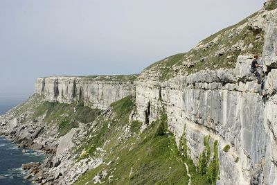 Rocky coastal feature against clear sky