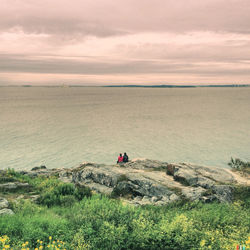 Scenic view of sea against cloudy sky