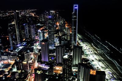 Aerial view of city lit up at night