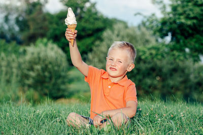 Portrait of cute boy on field