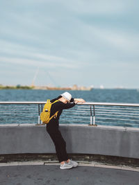 An asian woman feeling the wind, feeling relaxed at the pier against scenic view