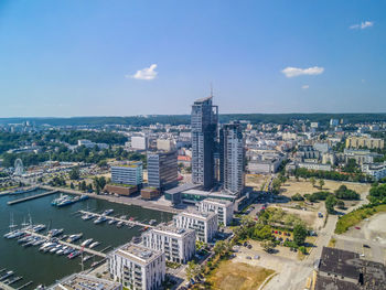 High angle view of buildings and sea against sky