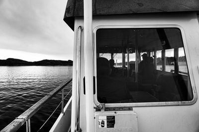 People sitting in boat against window