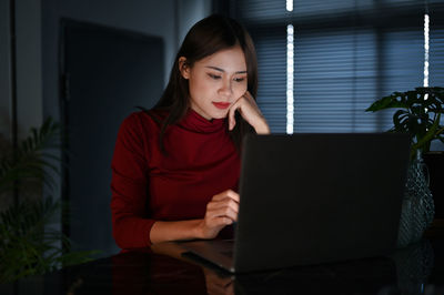 Young woman using laptop at home