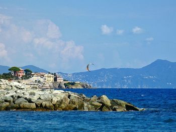 Scenic view of sea and buildings against sky