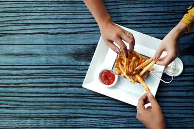 Low angle view of woman holding food on table