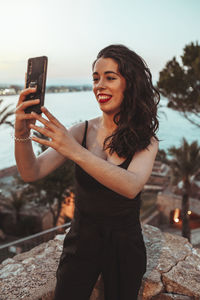 Young woman using mobile phone outdoors