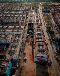 High angle view of vehicles on road amidst buildings in city