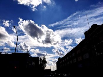 Low angle view of silhouette buildings against sky