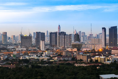 Aerial view of modern buildings in city against sky