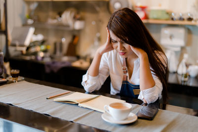 Woman sitting on table