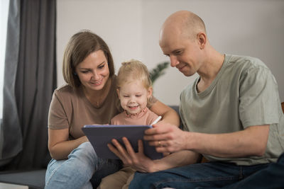 Side view of young man using laptop at home