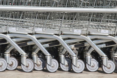 Wheels of supermarket shopping carts lined up in a row 