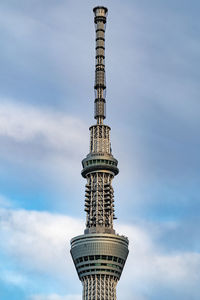 Low angle view of building against cloudy sky