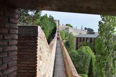 Footpath by building against sky