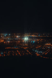 High angle view of illuminated city buildings at night