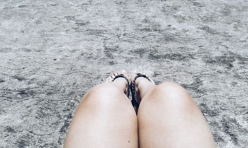 Low section of woman standing on tiled floor