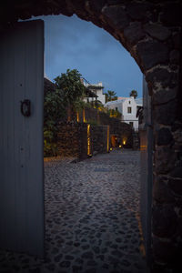 Alley amidst buildings in city at night