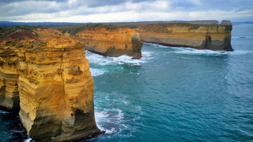 Rock formation in sea against sky