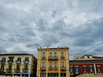 Low angle view of building against cloudy sky