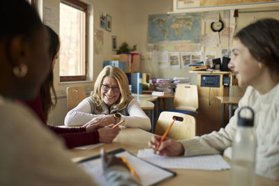 Teacher talking to students in class