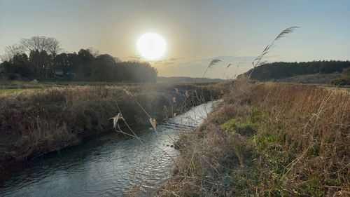 Scenic view of land against sky during sunset